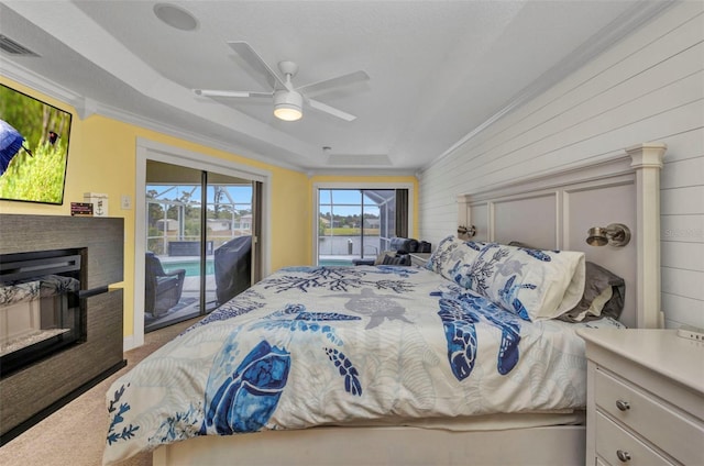 474 Lomond Dr, Port Charlotte, FL 33953 - bedroom with access to outside, crown molding, carpet, a glass covered fireplace, and a ceiling fan