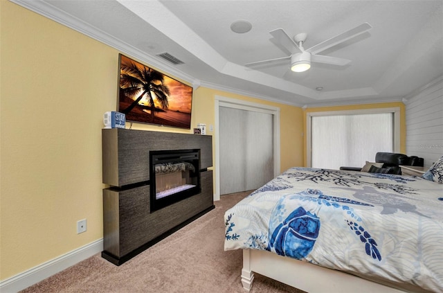 474 Lomond Dr, Port Charlotte, FL 33953 - bedroom with a raised ceiling, carpet, crown molding, a glass covered fireplace, and a ceiling fan