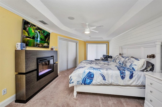 474 Lomond Dr, Port Charlotte, FL 33953 - bedroom with a raised ceiling, carpet flooring, a glass covered fireplace, a ceiling fan, and crown molding