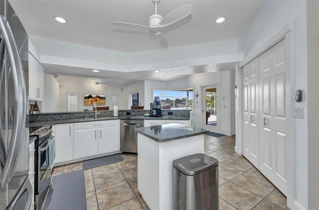 474 Lomond Dr, Port Charlotte, FL 33953 - kitchen featuring stainless steel appliances, a center island, a ceiling fan, white cabinetry, and dark stone countertops