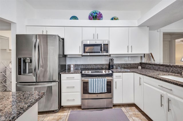 474 Lomond Dr, Port Charlotte, FL 33953 - kitchen featuring appliances with stainless steel finishes, white cabinets, and dark stone countertops
