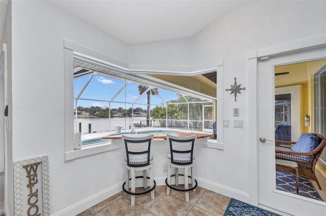 474 Lomond Dr, Port Charlotte, FL 33953 - dining area featuring a sunroom, healthy amount of natural light, baseboards, and a water view