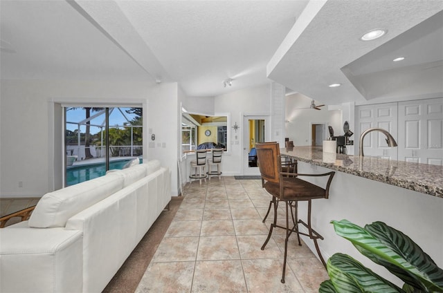 474 Lomond Dr, Port Charlotte, FL 33953 - living area with light tile patterned flooring, ceiling fan, baseboards, a textured ceiling, and recessed lighting