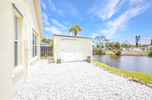 474 Lomond Dr, Port Charlotte, FL 33953 - view of shed with a water view and fence