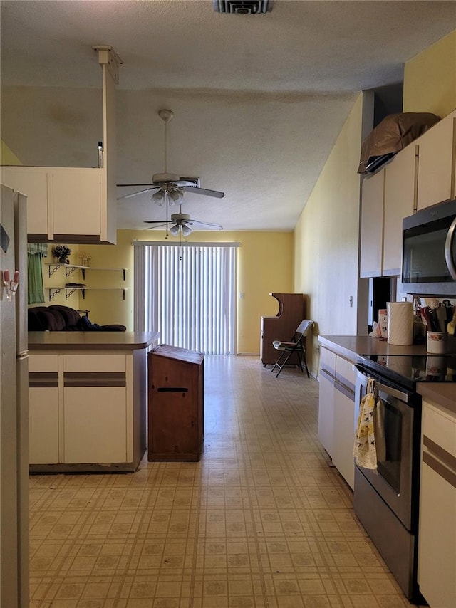 21161 Knollwood Ave, Port Charlotte, FL 33952 - kitchen with stainless steel appliances, light floors, white cabinets, and ceiling fan