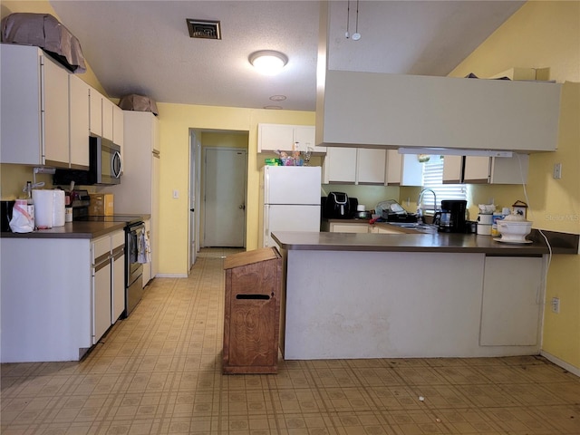 21161 Knollwood Ave, Port Charlotte, FL 33952 - kitchen featuring range with electric stovetop, freestanding refrigerator, dark countertops, a peninsula, and white cabinets