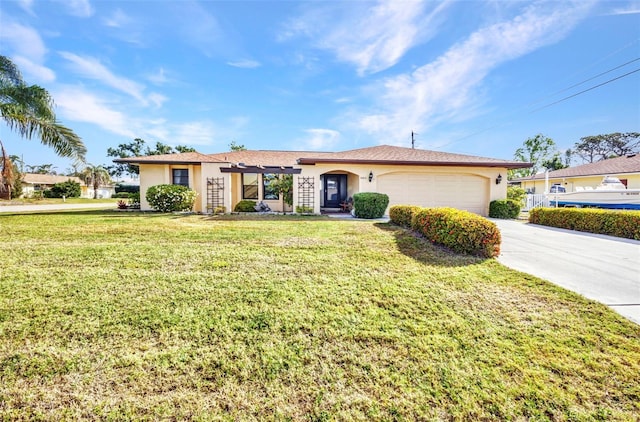 single story home featuring a garage, driveway, a front yard, and stucco siding