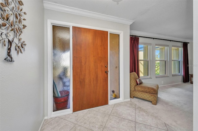 tiled entrance foyer with crown molding and baseboards