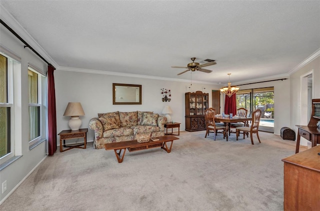 living room with ornamental molding, carpet, and ceiling fan with notable chandelier