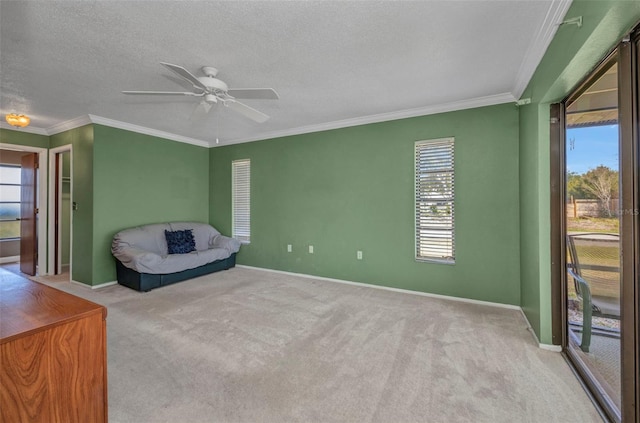 unfurnished room with baseboards, ornamental molding, carpet flooring, and ceiling fan