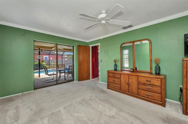 carpeted bedroom featuring access to outside, ornamental molding, a ceiling fan, and visible vents