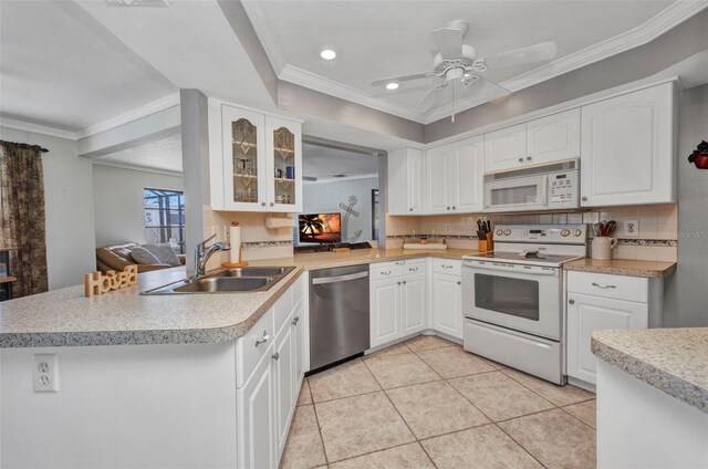 kitchen with crown molding, a sink, light tile patterned floors, glass insert cabinets, and white appliances
