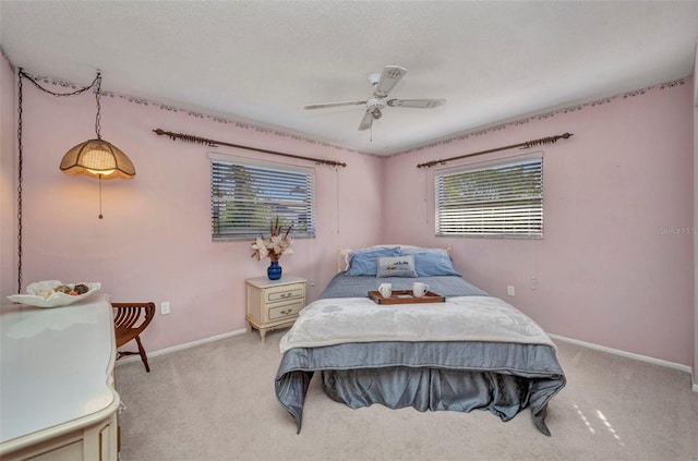 bedroom with baseboards, light carpet, and ceiling fan