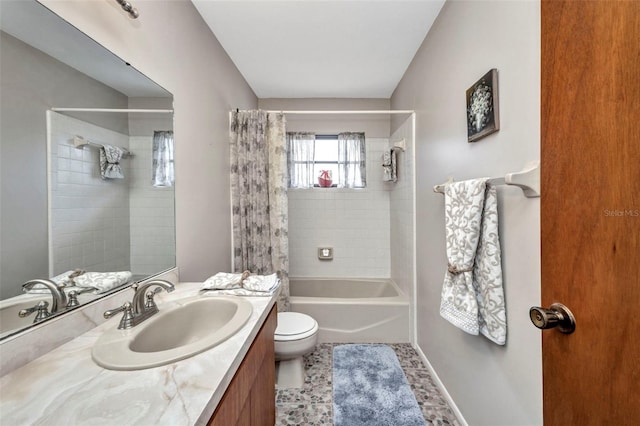 bathroom with vanity, toilet, and shower / tub combo
