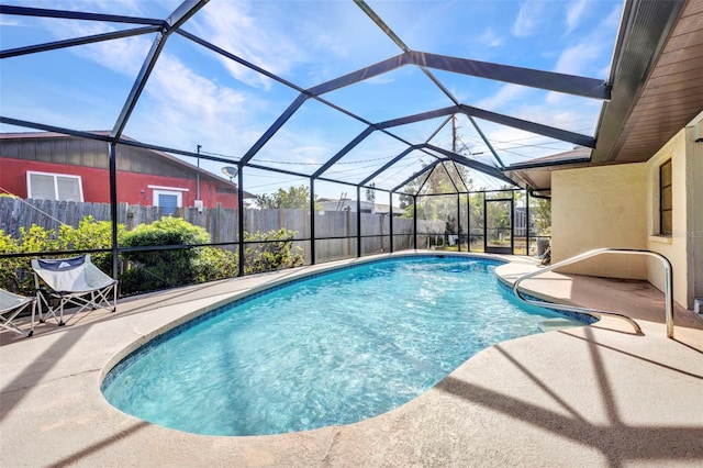 view of pool with a lanai, a patio, a fenced in pool, and fence