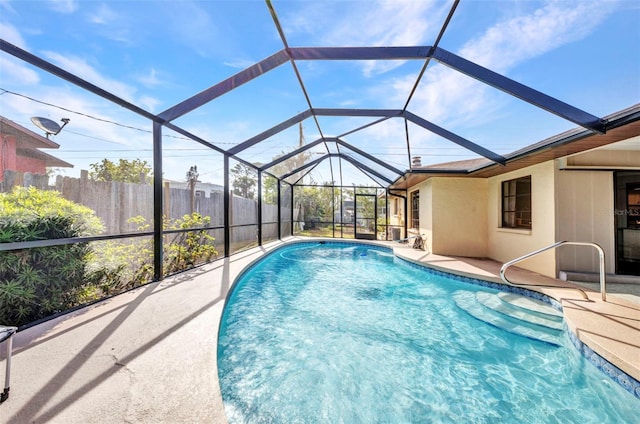view of swimming pool featuring a fenced in pool, fence, a patio, and glass enclosure