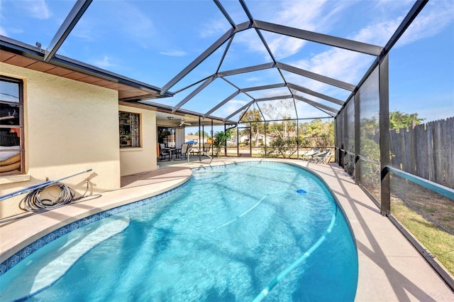 view of pool with a fenced in pool, fence, a lanai, and a patio area
