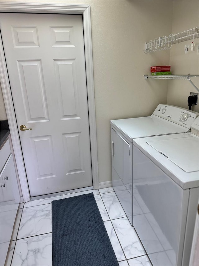 1025 Boundary Blvd, Rotonda West, FL 33947 - washroom featuring washer and dryer, laundry area, and marble finish floor