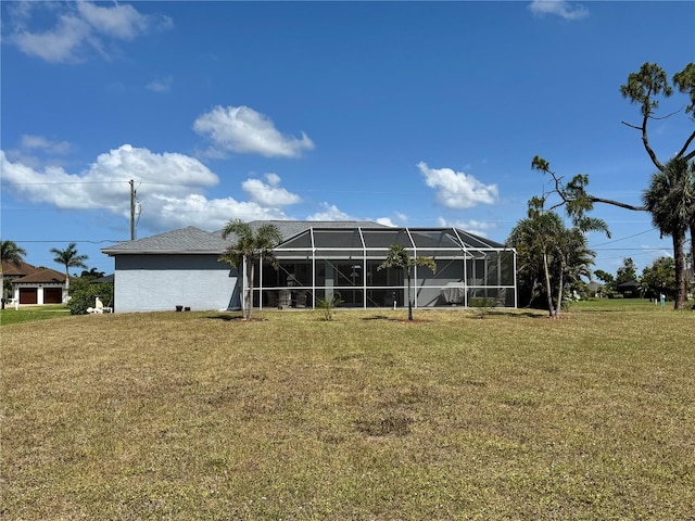 1025 Boundary Blvd, Rotonda West, FL 33947 - rear view of house with glass enclosure and a yard