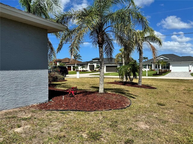 1025 Boundary Blvd, Rotonda West, FL 33947 - view of yard with a garage and driveway