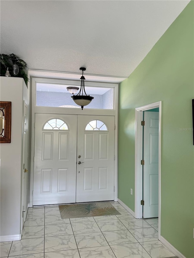 1025 Boundary Blvd, Rotonda West, FL 33947 - foyer entrance with baseboards and marble finish floor