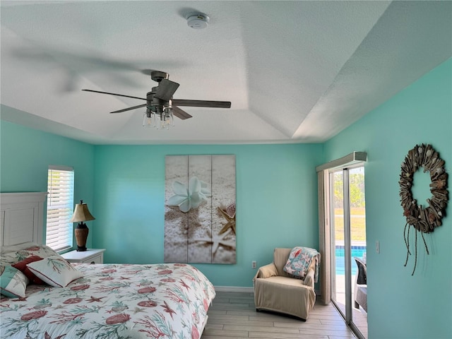 1025 Boundary Blvd, Rotonda West, FL 33947 - bedroom featuring vaulted ceiling, ceiling fan, wood finished floors, and access to exterior