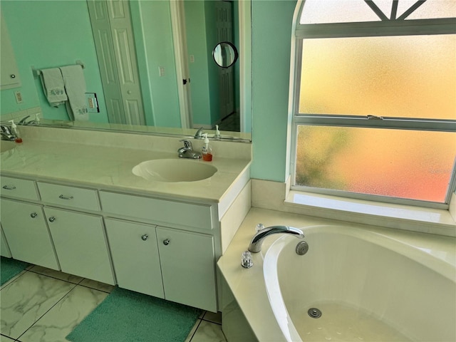 1025 Boundary Blvd, Rotonda West, FL 33947 - bathroom featuring a garden tub, marble finish floor, and vanity