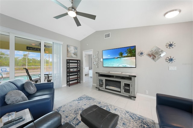tiled living room with a ceiling fan, lofted ceiling, and baseboards
