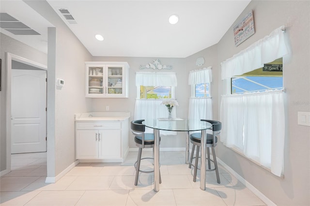 dining area featuring baseboards, light tile patterned flooring, and recessed lighting