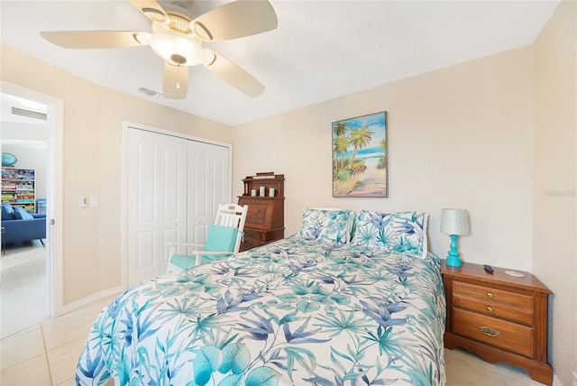 bedroom featuring light tile patterned floors, a closet, and a ceiling fan