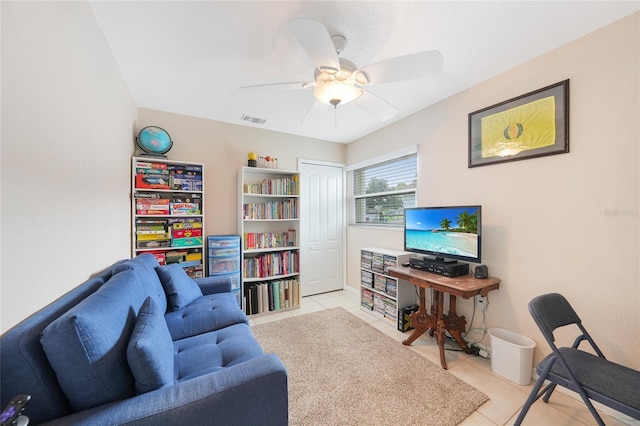 living room featuring light tile patterned floors and ceiling fan