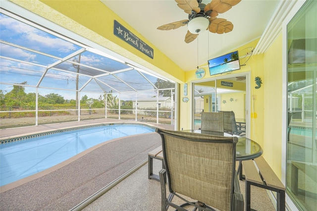 swimming pool featuring ceiling fan, a lanai, and a patio