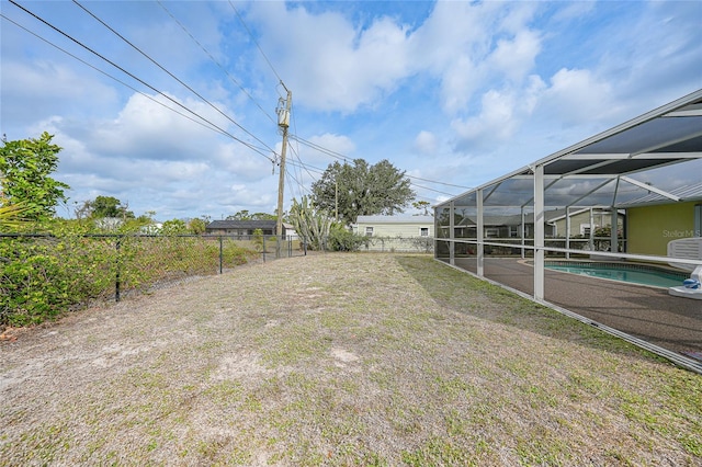 view of yard featuring an outdoor pool and a lanai