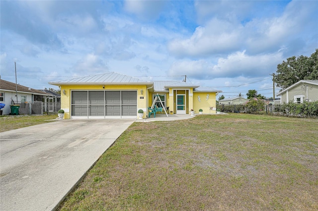 view of front facade featuring stucco siding, an attached garage, concrete driveway, a standing seam roof, and metal roof