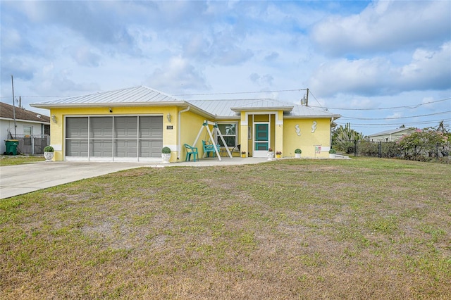 ranch-style house featuring a standing seam roof, stucco siding, driveway, and an attached garage