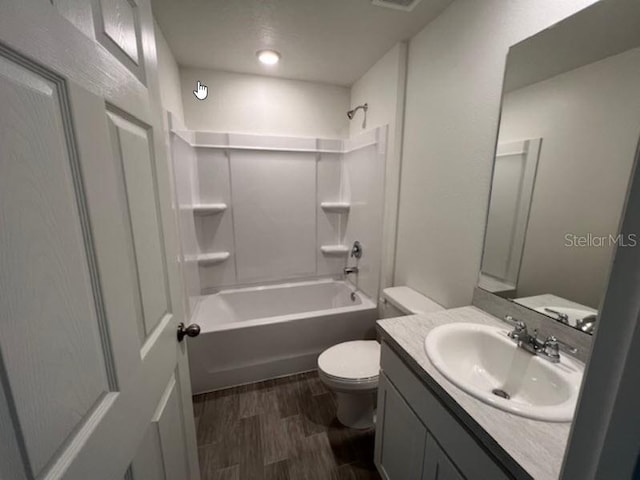 full bathroom with toilet, wood finished floors, shower / bathing tub combination, and vanity