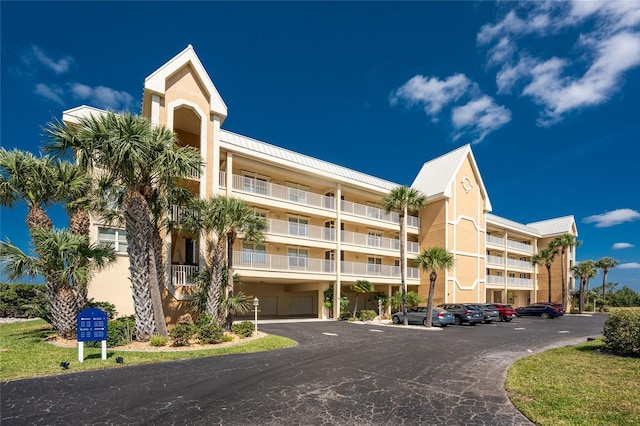 view of building exterior with uncovered parking