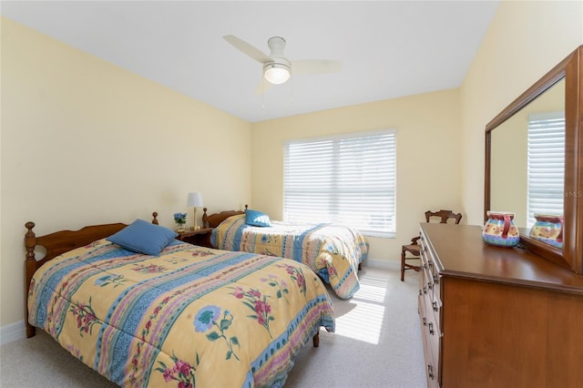 bedroom featuring baseboards, ceiling fan, and carpet