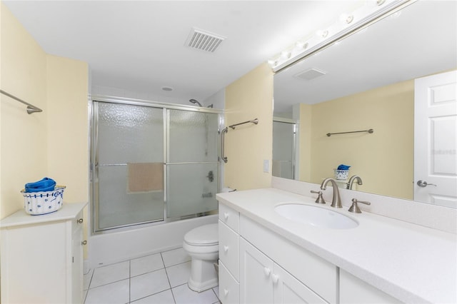 bathroom with toilet, tile patterned floors, vanity, and visible vents