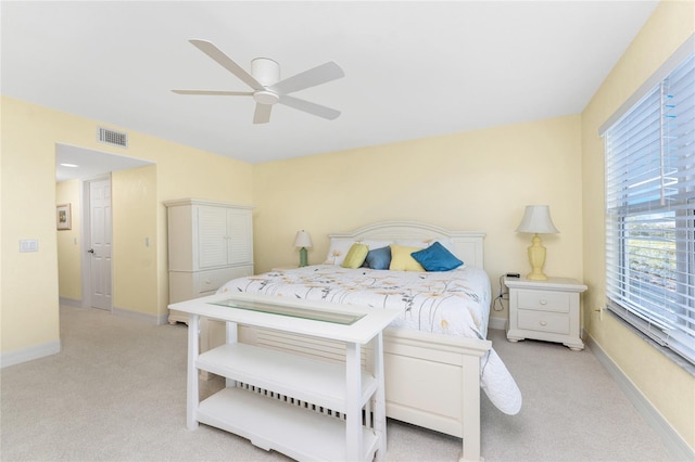 bedroom with visible vents, baseboards, and light carpet