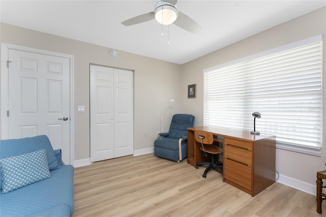 office with light wood finished floors, baseboards, and a ceiling fan