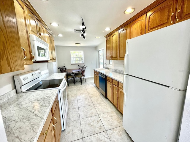 kitchen featuring a sink, brown cabinetry, visible vents, white appliances, and recessed lighting