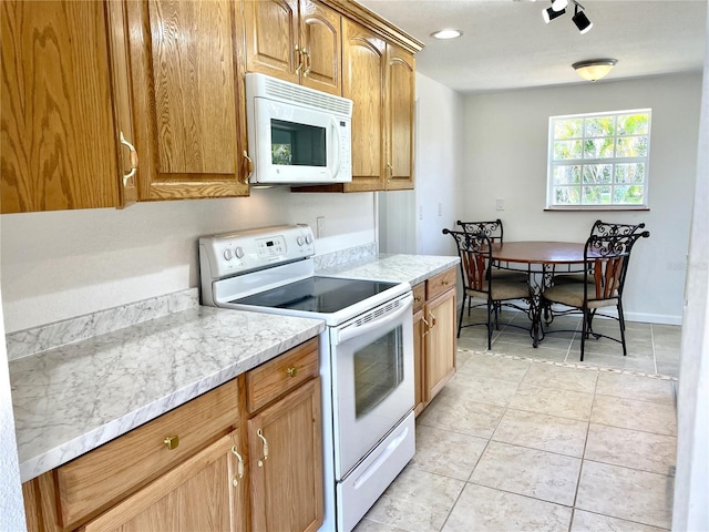 kitchen with light tile patterned flooring and white appliances