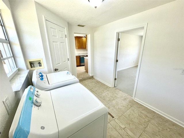 laundry room featuring laundry area, washer and clothes dryer, and baseboards