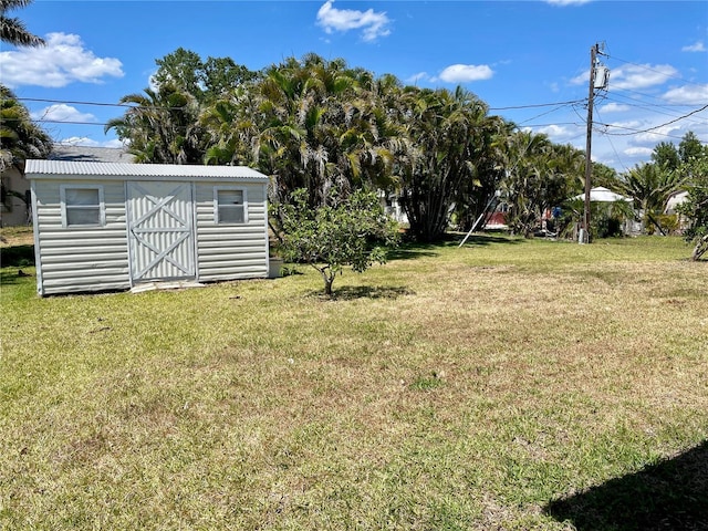 view of yard featuring an outdoor structure and a shed