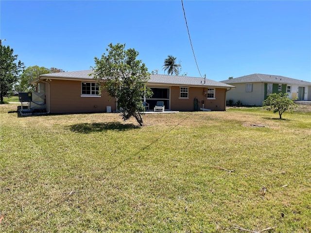 back of house with a lawn
