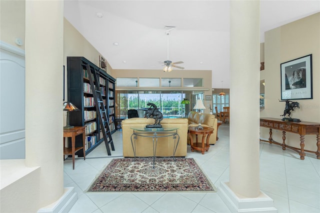 tiled living area with a ceiling fan and a towering ceiling