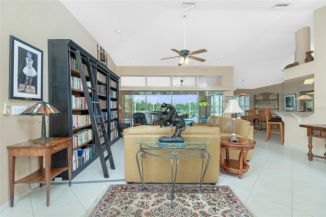 living room featuring a ceiling fan, visible vents, light tile patterned floors, baseboards, and high vaulted ceiling