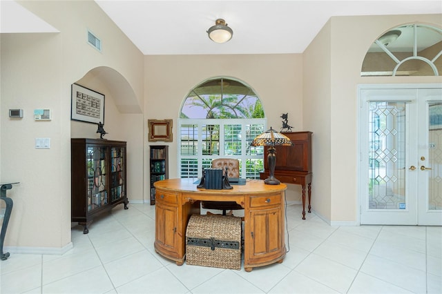 office area featuring light tile patterned flooring, baseboards, visible vents, and french doors