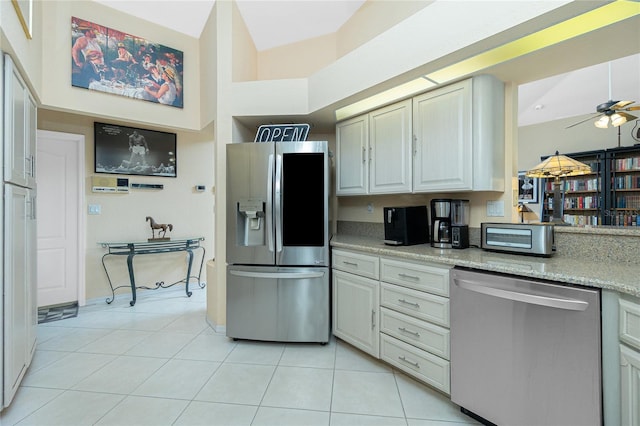 kitchen featuring ceiling fan, light tile patterned flooring, and stainless steel appliances